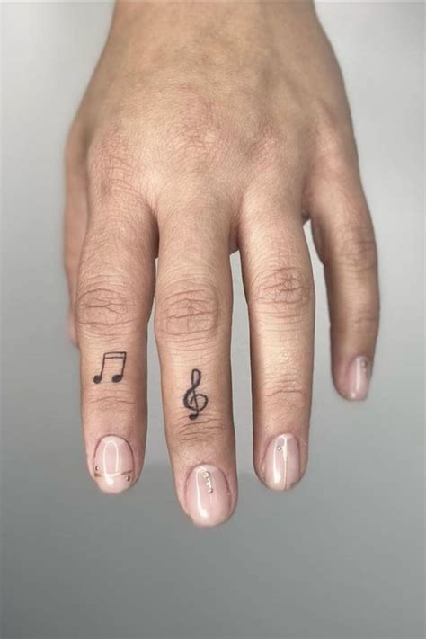 music note finger tattoo|More.